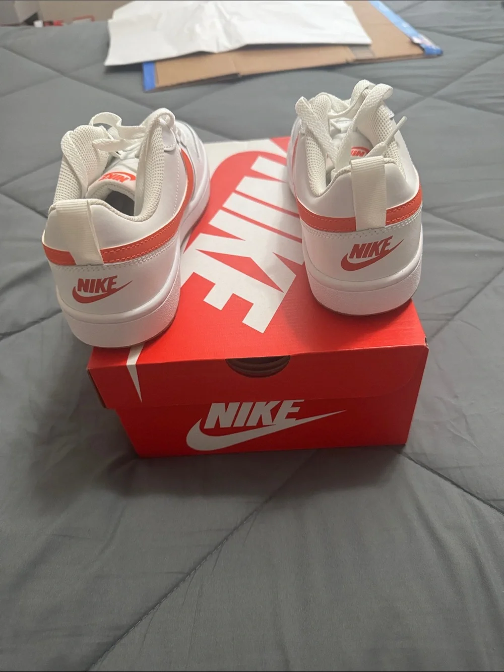 Nike Kids White Sneakers with Orange Swoosh Accent